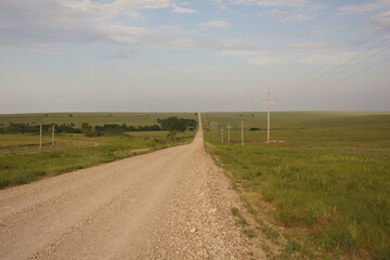 Fototapeta na wymiar A country road in the wide open Kansas prairie.