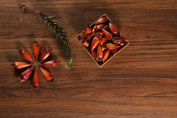 Typical araucaria seeds used as a condiment in Brazilian cuisine in winter. Top view Brazilian pinion on wooden background
