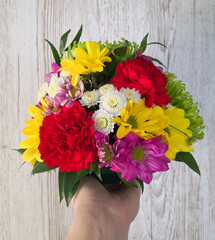 Bright colorful spring flowers bouquet handheld.  Mother's Day, Valentine's Day, greeting card.