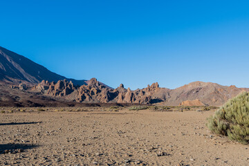Totally deserted place with volcanic mountains and some bushes on the teide in the island of tenerife in spain