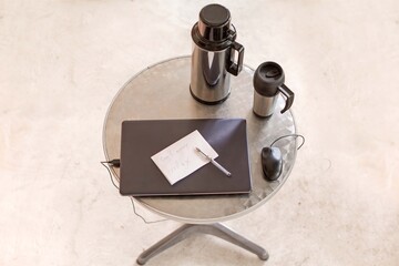 Laptop Cup Table in chrome design on white background, no people empty home office 