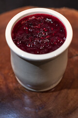Homemade cheese cake with red fruit jam made in a ceramic jar