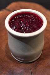 Homemade cheese cake with red fruit jam made in a ceramic jar