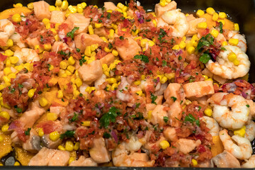 Salmon ceviche with red pepper, coriander, corn and lime