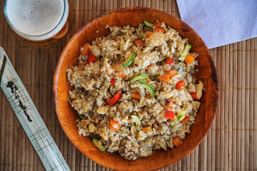 Overview of a chinese rice bowl at home with a beer