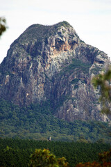 Glass House Mountains, Sunshine Coast, Queensland, Australia showing blue sky, mountains, paddocks, farming land and forests