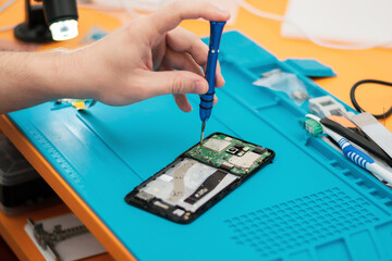 Technician repairing mobile phone, motherboard fix, concept of computer hardware, electronic, ...