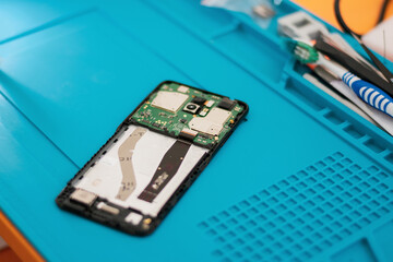 Technician repairing mobile phone, motherboard fix, concept of computer hardware, electronic,...