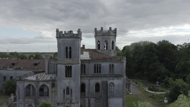 Abandoned palace 19th century (manor or mansion house) with broken windows in Neo-Gothic (Gothic Revival) style. Aerial side view