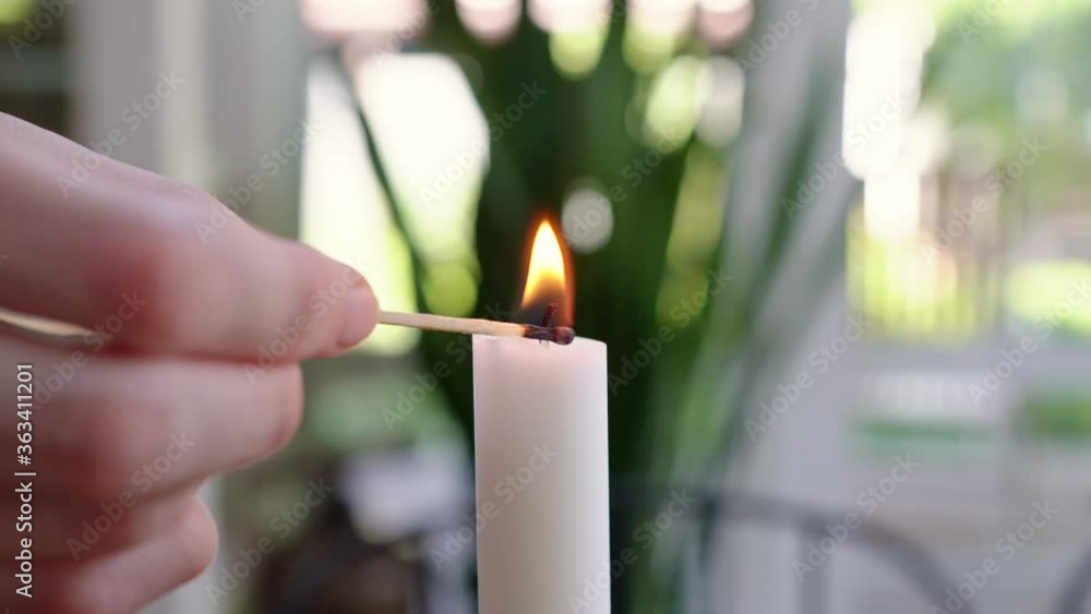 Poster close-up. candle lit with a match. decoration decor or romantic dinner.