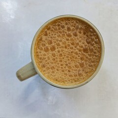 A cup of teh tarik also know as pulled tea. Popular hot milk tea beverage. It is the national drink of Malaysia.