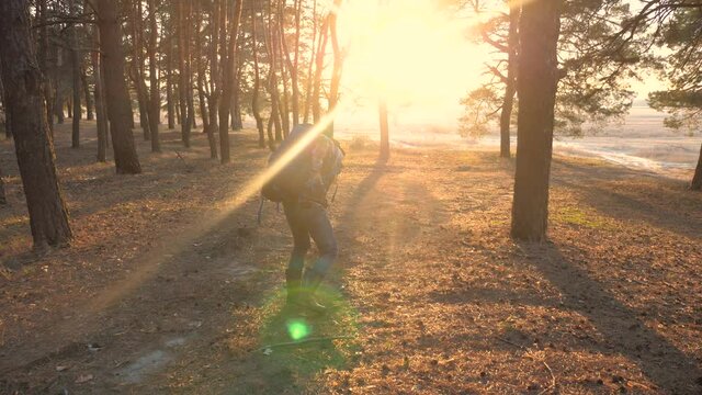 concept sciatic rheumatism back pain the medicine. man traveler tourist with a backpack pulled his back tired face pain. hiker concept lifestyle travel difficulties tourism sunlight sunset