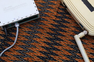 hand holding wifi router. router wireless wire broadband home office cable plug concept