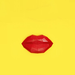 Kissing woman lips red colored on yellow paper background. Greeting card design with copy space. Beautiful close up kiss 3d volume paper object.