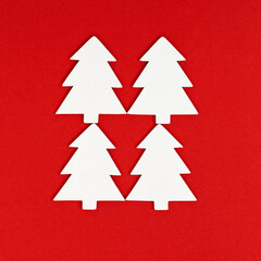 New years Christmas tree white color on red background. Christmas greeting card. Minimal style.