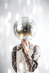 sparkle filtered image of a man holding a disco ball