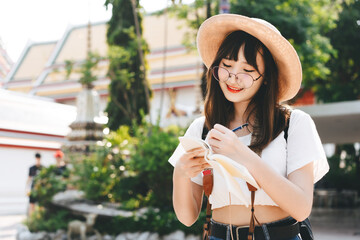 Young asian cute glasses teenager girl traveller backpack solo local travel with memo written daily.