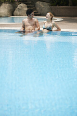 Man and woman relaxing in pool