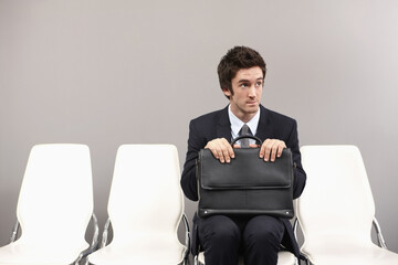 Businessman sitting on chair, waiting