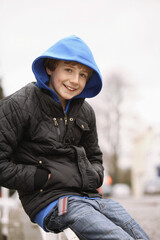 Boy sitting outdoors