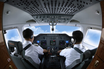 Pilot and co-pilot in private jet cockpit © ImageHit