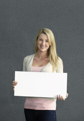 Woman holding a blank placard