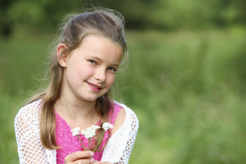 Girl holding small flowers