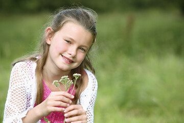 Girl holding small flowers