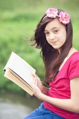 Girl reading a book outdoors