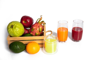 Mixed fresh law fruit and fruit joice in glasses on whiet background