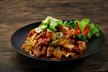 Spicy Kimchi stir fried with Pork (Dwaejigogi Kimchi Bokkeum) ontop Chili and garlic Korean Food