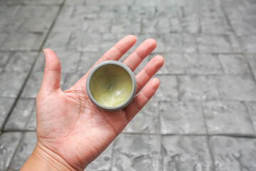 people left hand hold setting wax product in for hair styling
