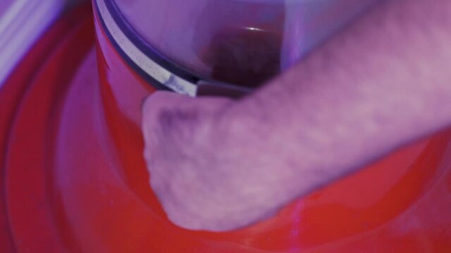 Man hand and arm only taking gum out of bubble gum vending machine, Static