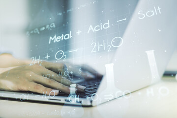 Double exposure of creative chemistry concept with hands typing on laptop on background, research and development concept