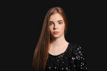 Beautiful young redhead woman on dark background