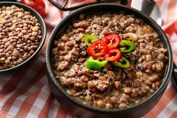 Bowl of tasty lentils soup on table