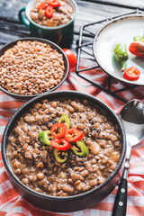 Bowl of tasty lentils soup on table