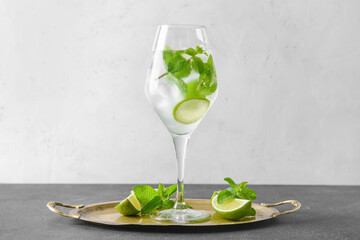 Glass of fresh mojito on table