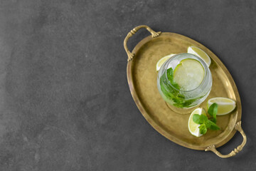 Glass of fresh mojito on dark background