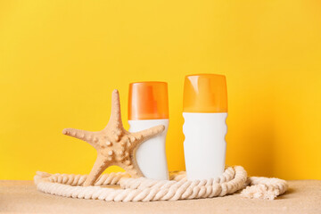 Bottles of sunscreen on color background