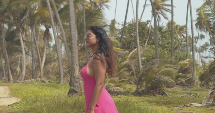 A model plays with her hair in the wind at a coconut estate on the Caribbean island of Trinidad and Tobago