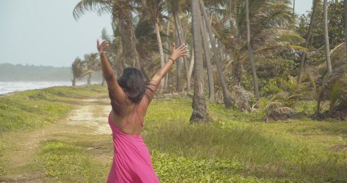 Sexy young lady turns 360 while enjoying the sea breeze at this amazing Caribbean beach location