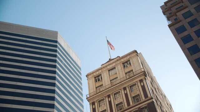 Big bank building in San Francisco - USA flag flickering in wind - Banking district USA