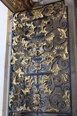 Gold carvings on black metallic doors of the St. Paul's Cathedral in London, UK