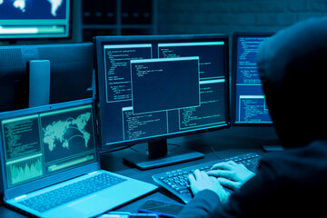 Asian male hacker use laptop