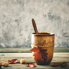 Cup of tea or coffee with autumn leaf