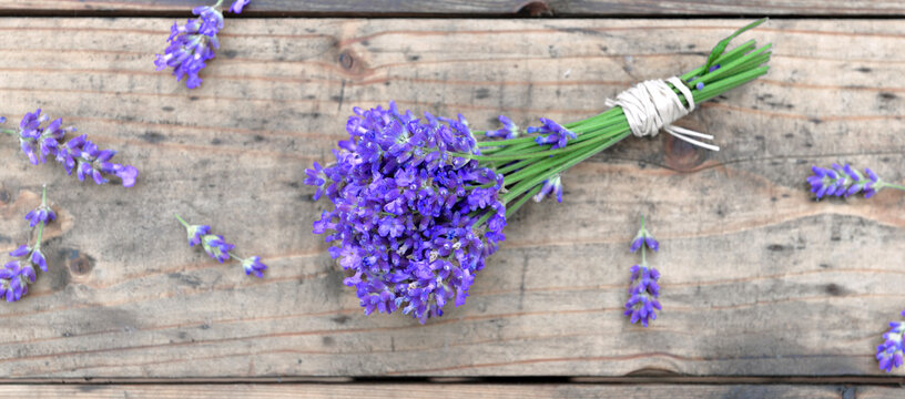 top view on a little bouquet of lavender flowers  on wooden background