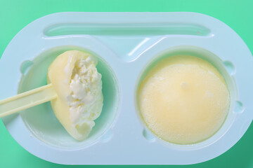 eating vanilla flaovr mochi dessert ice cream on green background