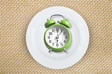 Fototapeta na wymiar Old vintage alarm clock on the plate and cutlery