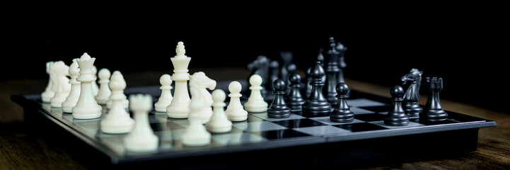 hand of businessman moving chess figure in competition board game for development analysis